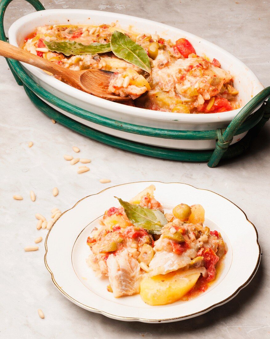 Salt cod alla messinese with potatoes, tomatoes and olives (Sicily)