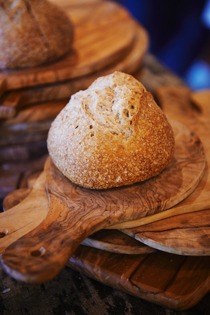 Crispy bread roll on a chopping board