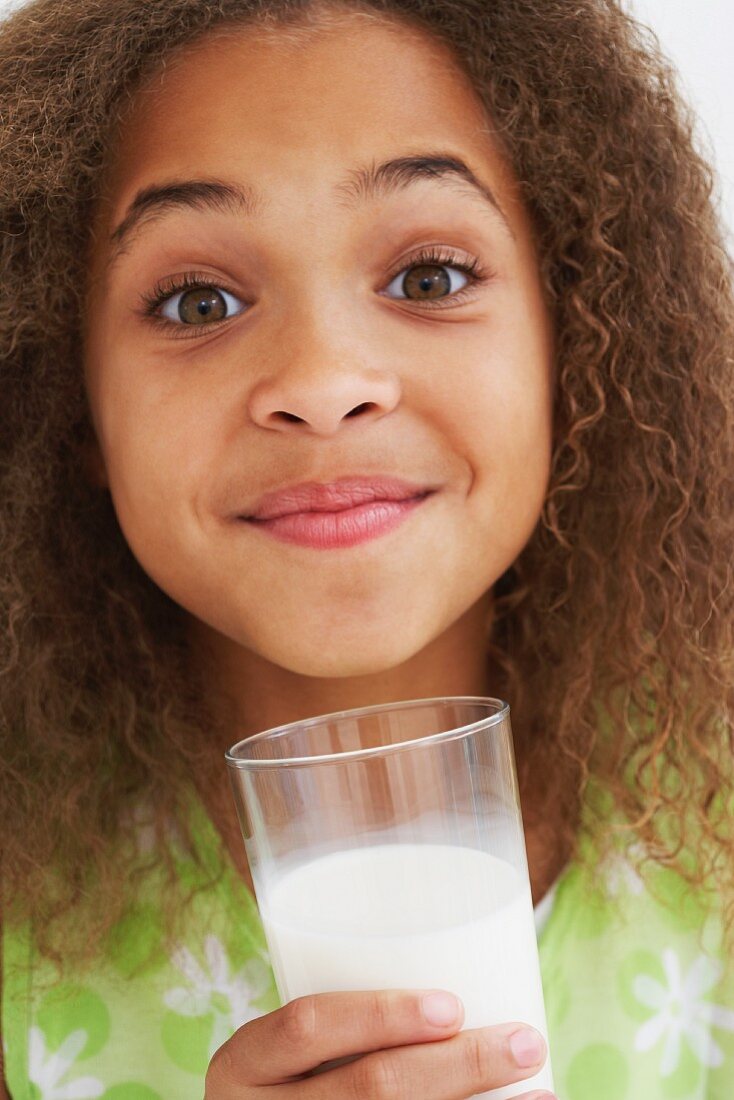 Close up of African American girl drinking milk