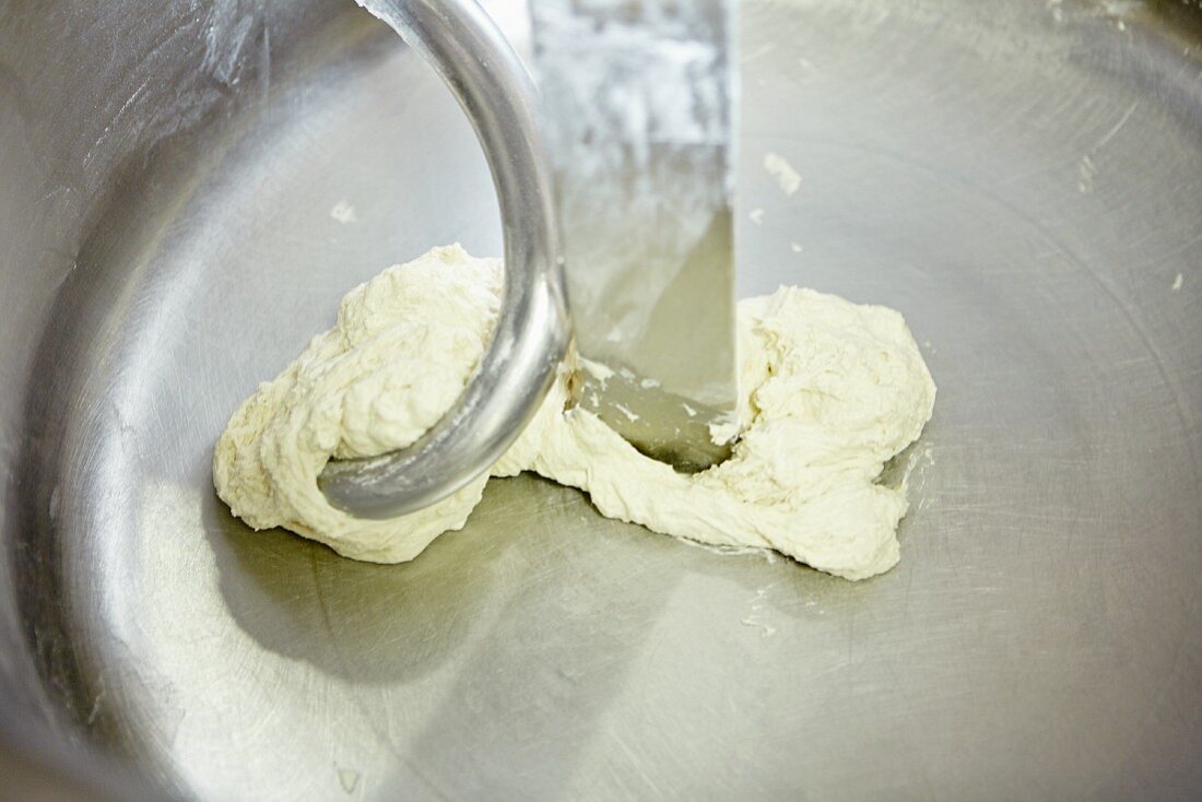 Bread dough being kneaded by a machine