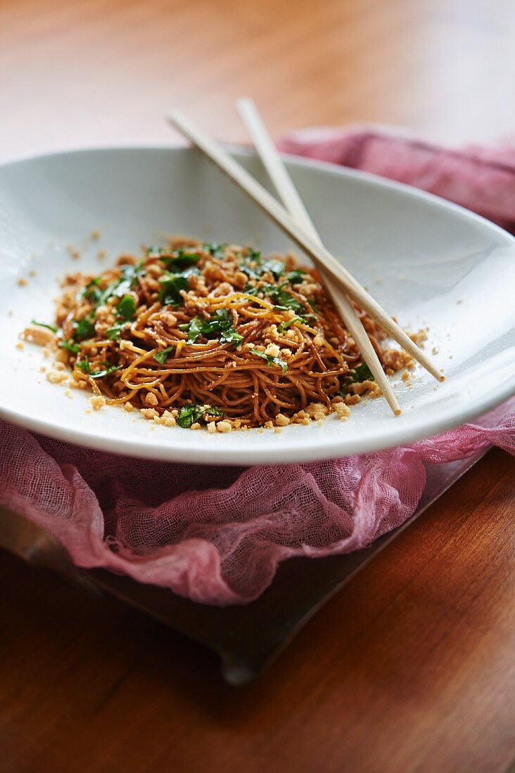 Chilled Sesame Noodles with crumbled roasted peanuts and a mix of basil, cilantro, and parsley