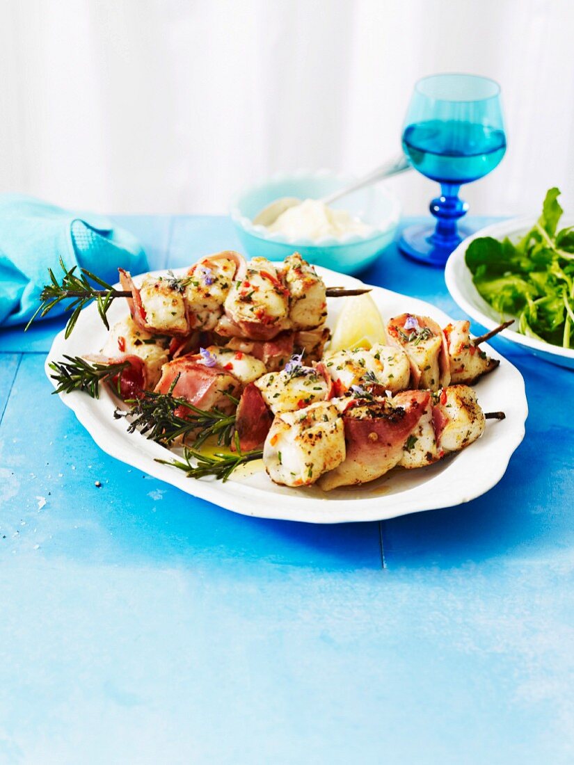Rosemary and fish skewers with Parma ham