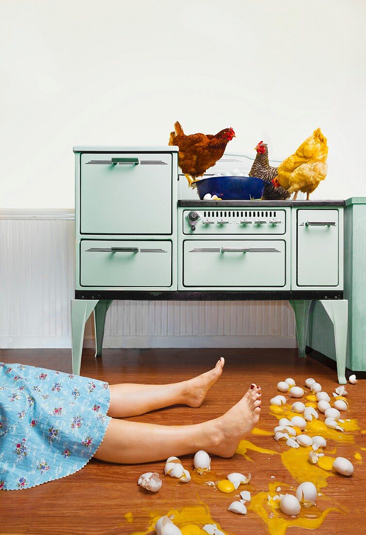 Caucasian woman on kitchen floor with broken eggs