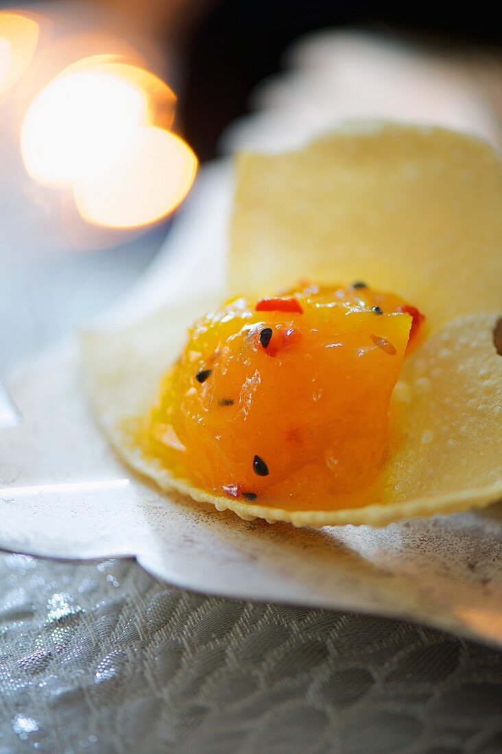 Mango and lemon chutney with chilli on a poppadom