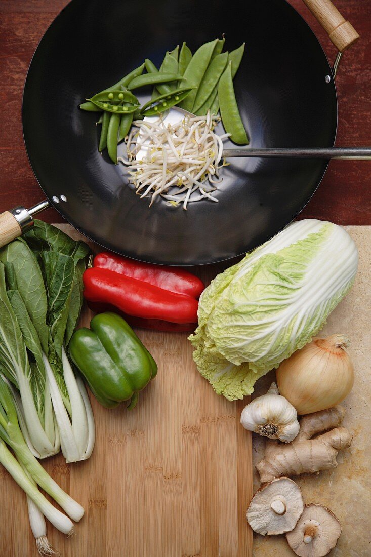Variety of Asian stir fry ingredients and wok