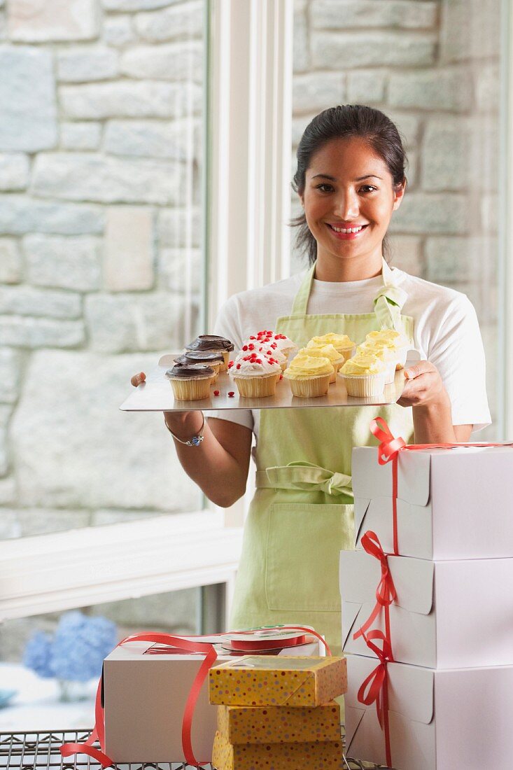 A woman packaging cupcakes