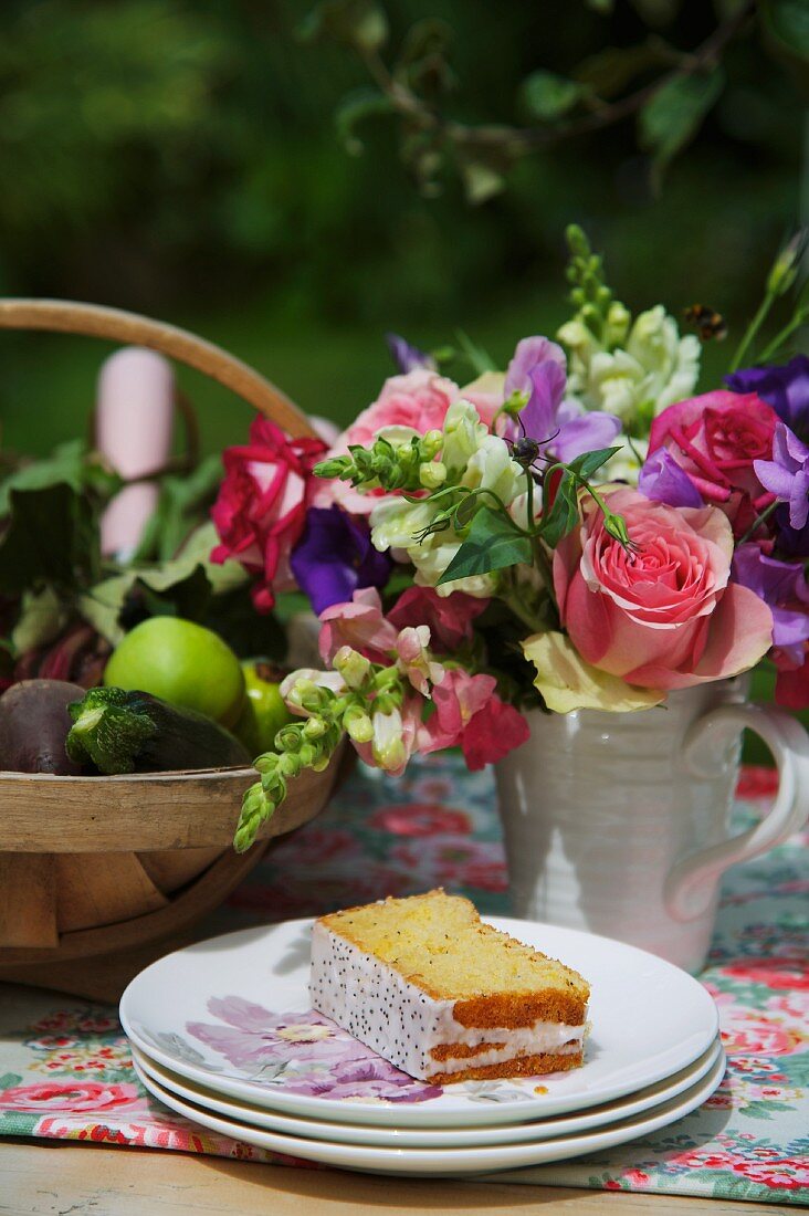 Lavender cake in front of a bunch of summer flowers