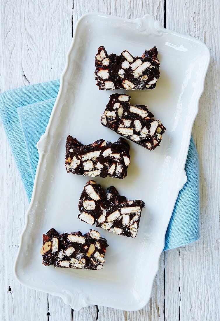 A few pieces of chocolate fridge cake on a serving plate