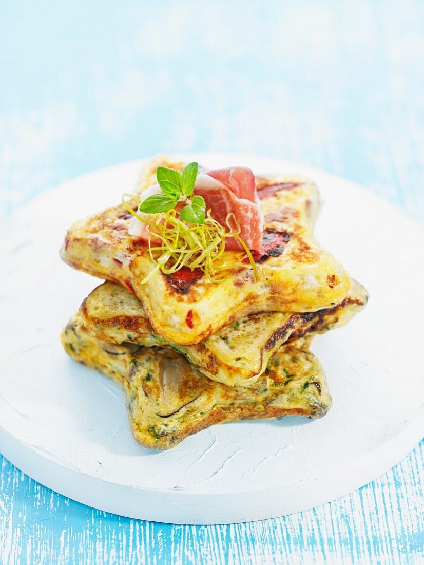 Star-shaped Spanish omelettes with dry-cured ham, stacked