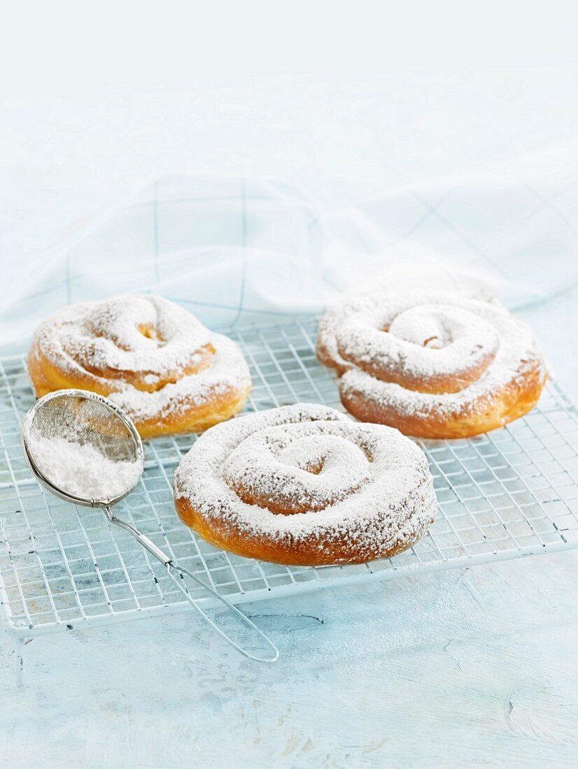 Ensaimadas (spiral pastries, Spain) dusted with icing sugar