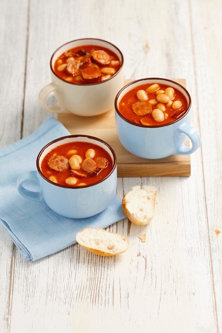 Beans with sausage and bacon in tomato sauce