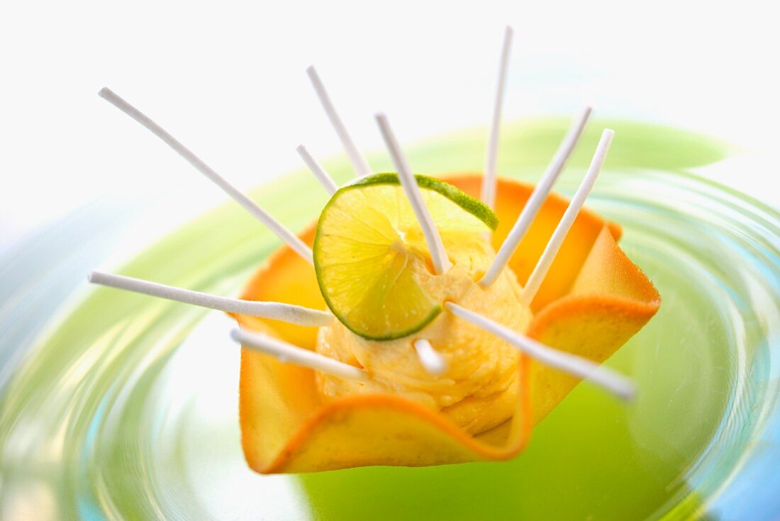 Lime ice cream in a wafer basket with meringue sticks