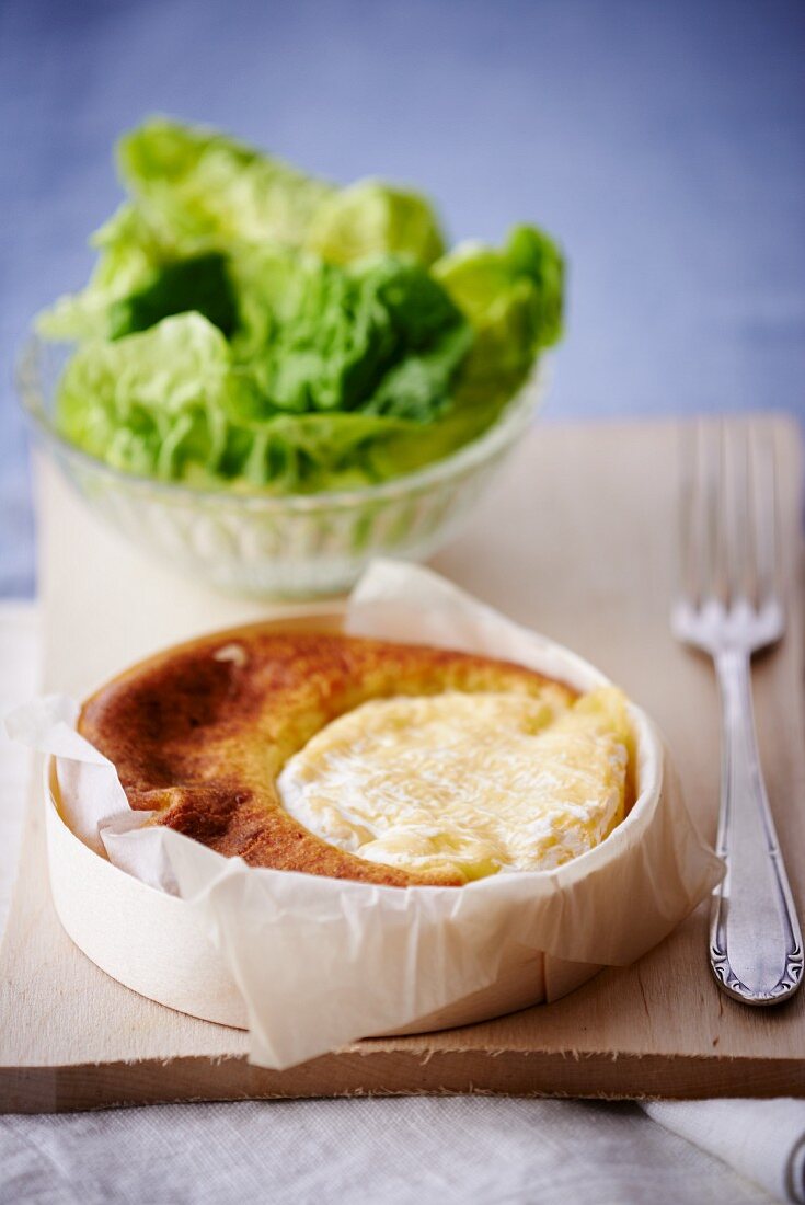 Baked Saint Marcellin cheese with lettuce