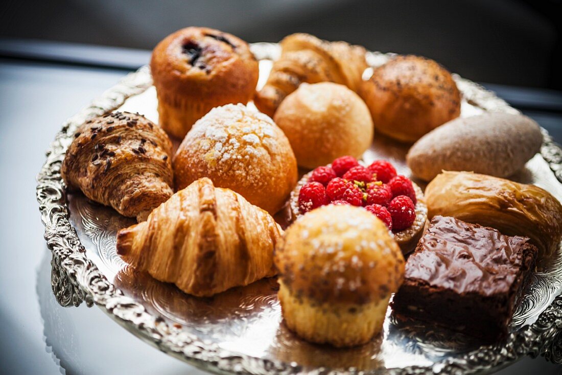 A selection of cakes and pastries on a silver tray