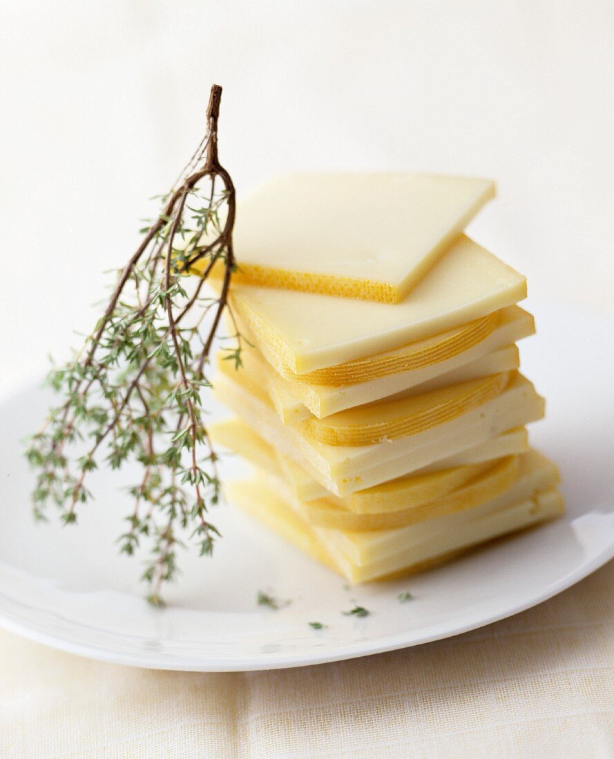 Raclette cheese, sliced, on a plate