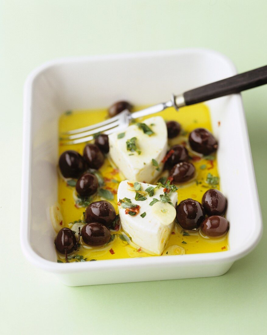 Ewe's cheese with olives in a herb marinade