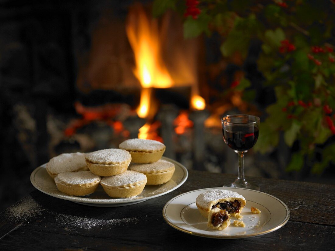 Mince pies and a glass of red wine in front of the fireplace