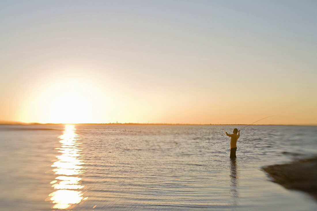 Man Fly Fishing at Sunrise, Florida Keys, USA
