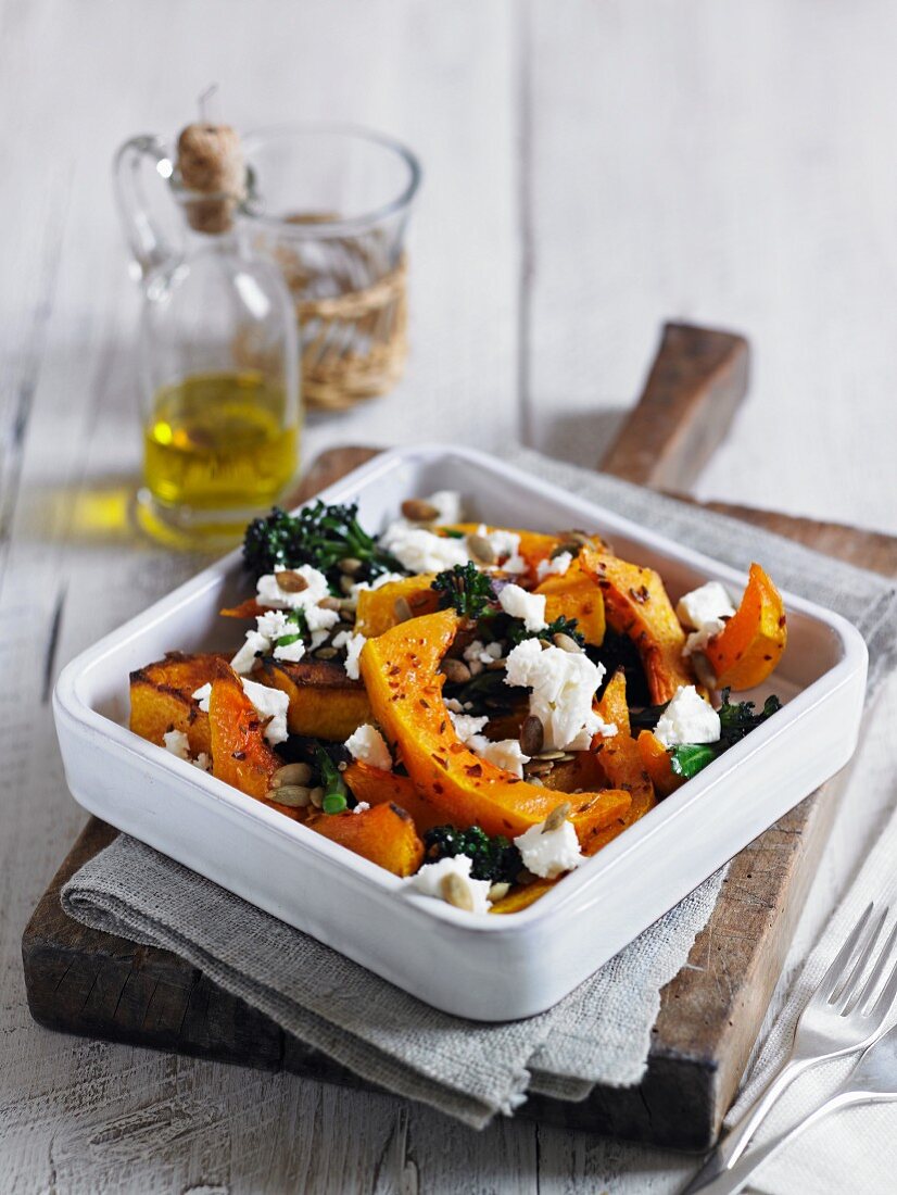 Baked squash with feta, broccoli and pumpkin seeds