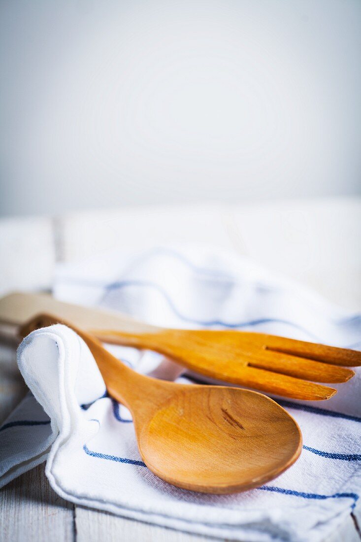 Wooden cooking utensils on a tea towel