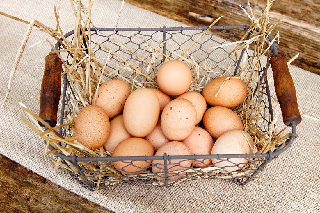 Fresh Brown and White Eggs in a Wire Basket