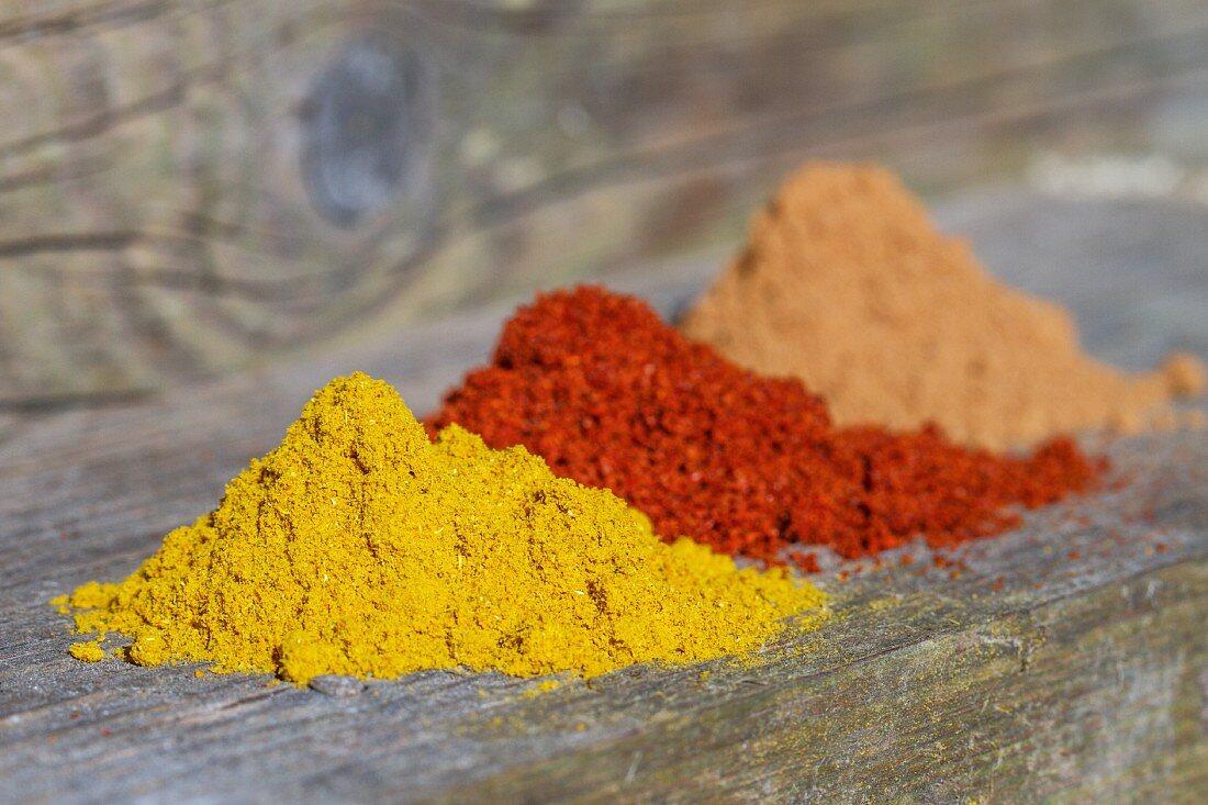 Three mounds of different spices