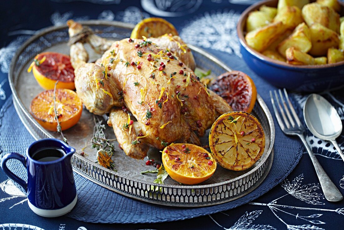 Roast chicken with glazed oranges and lemons