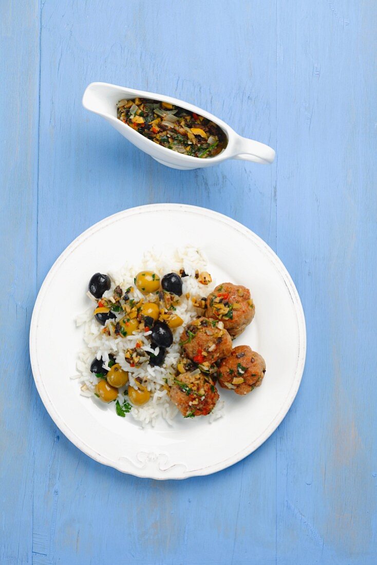 Pork meatballs with rice and olive sauce