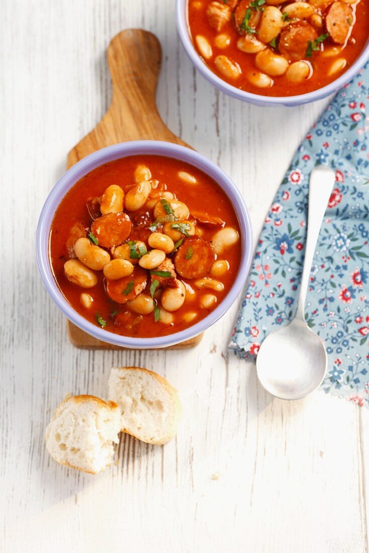 Beans with sausage and bacon in tomato sauce