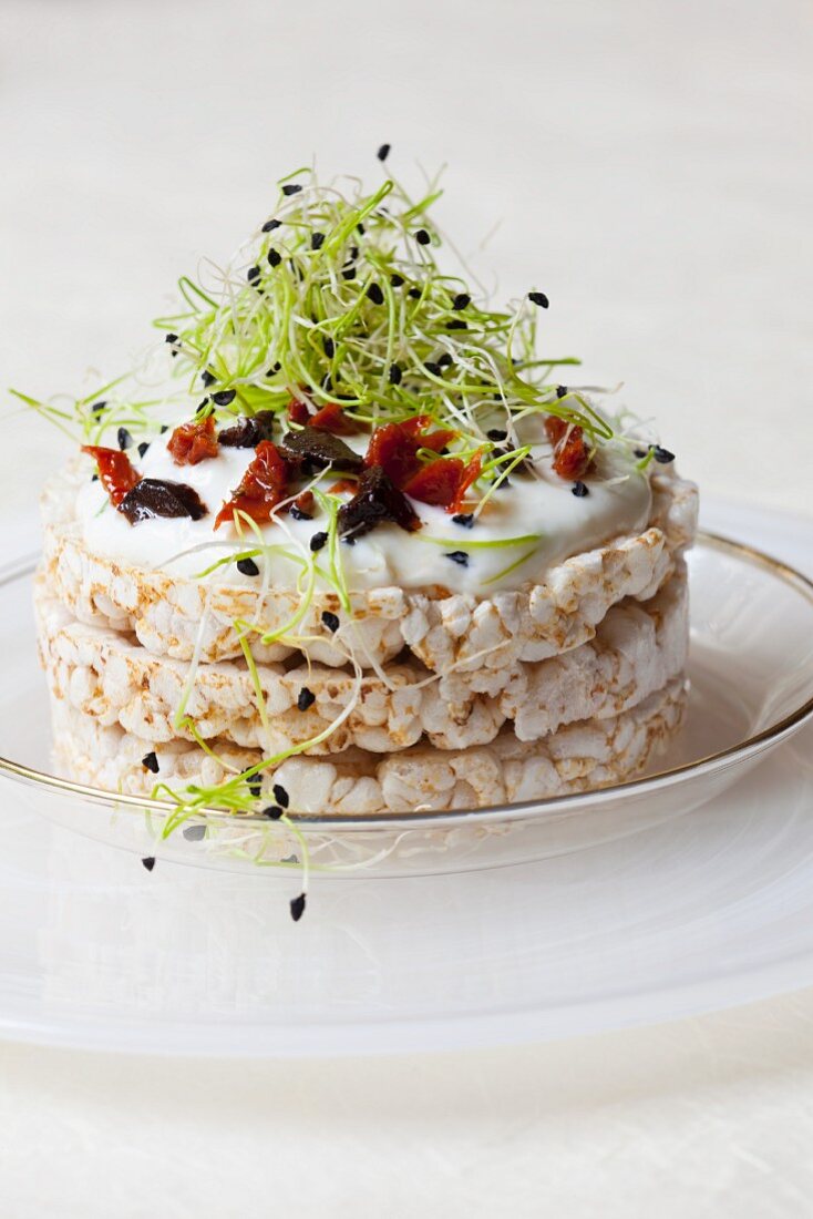 Rice waffles topped with quark, olives, dried tomatoes and bean sprouts