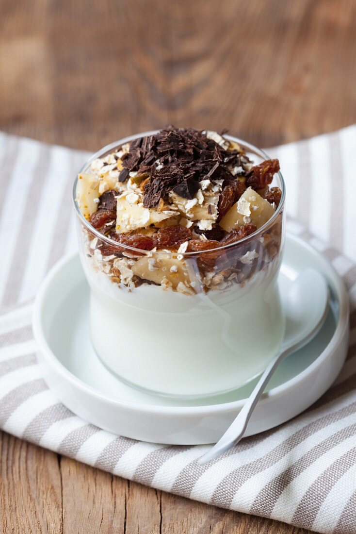 Yoghurt with oats, apple, dried fruits and grated chocolate