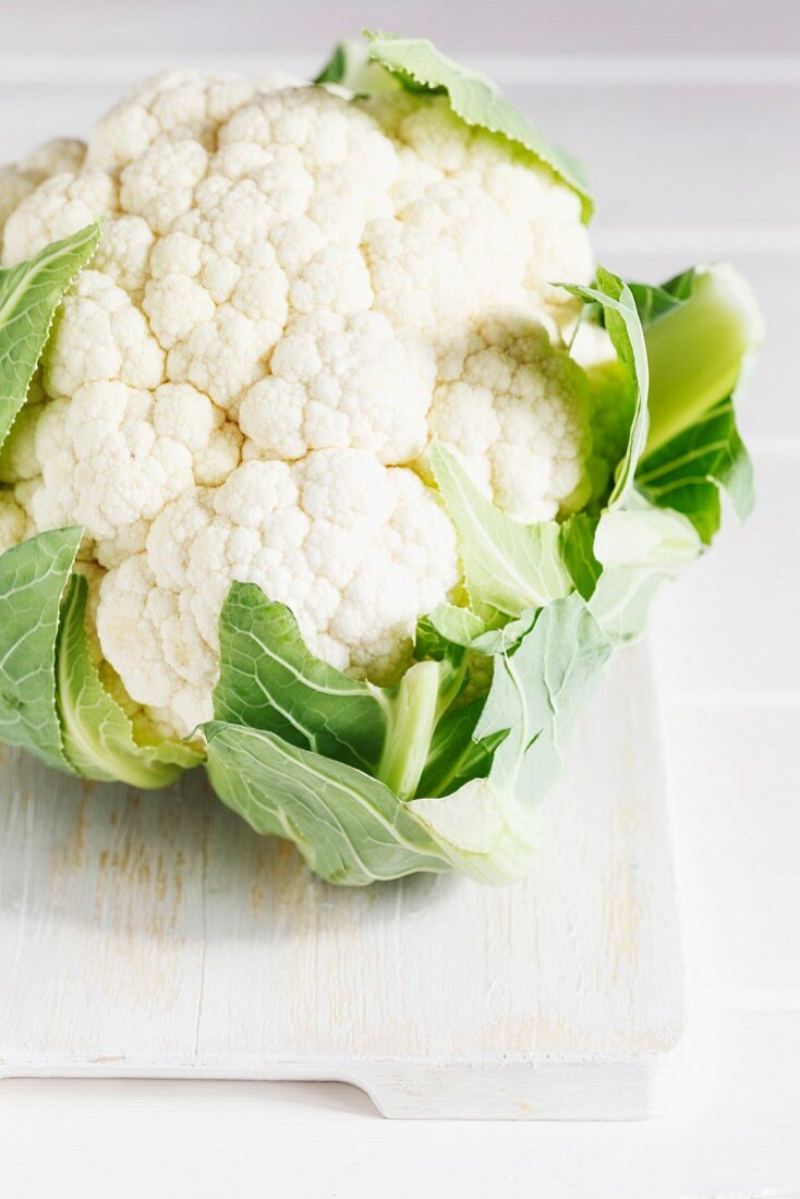 A cauliflower on a chopping board