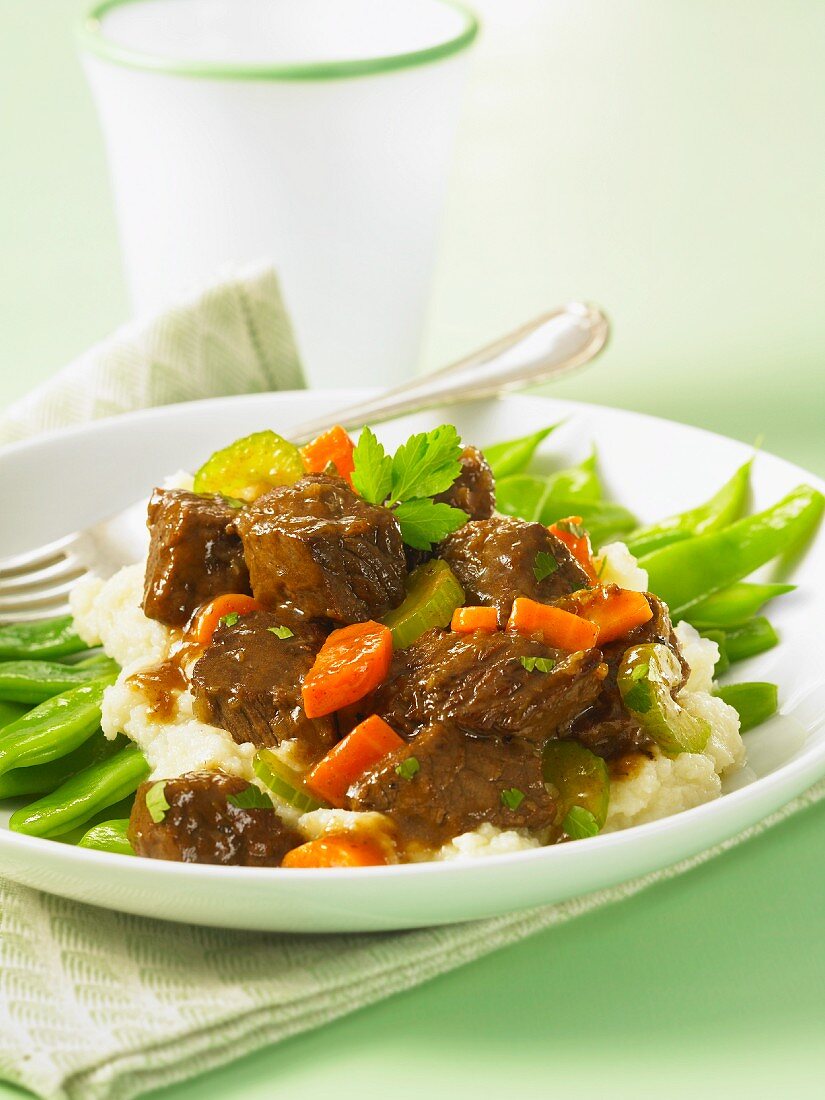 Beef stew with mashed potatoes and green beans