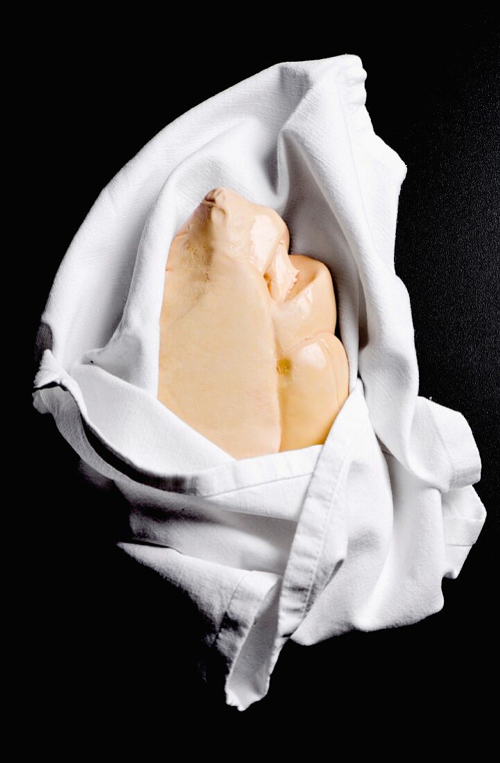 A whole goose liver in a linen cloth