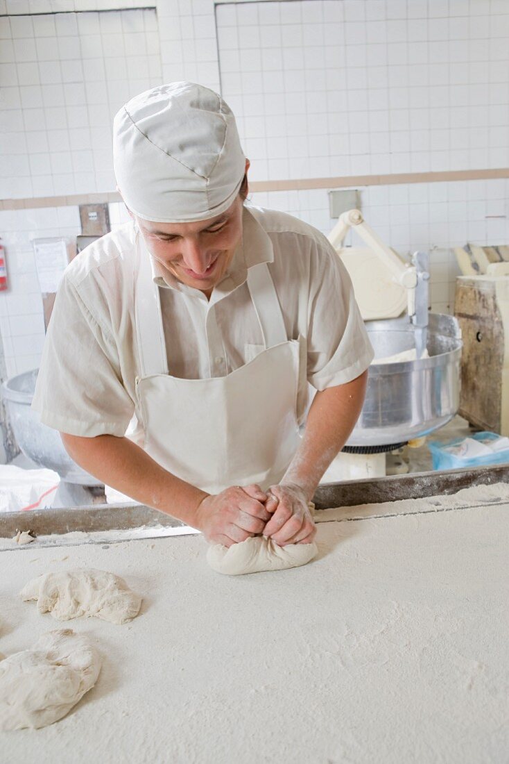 A baker kneading dough