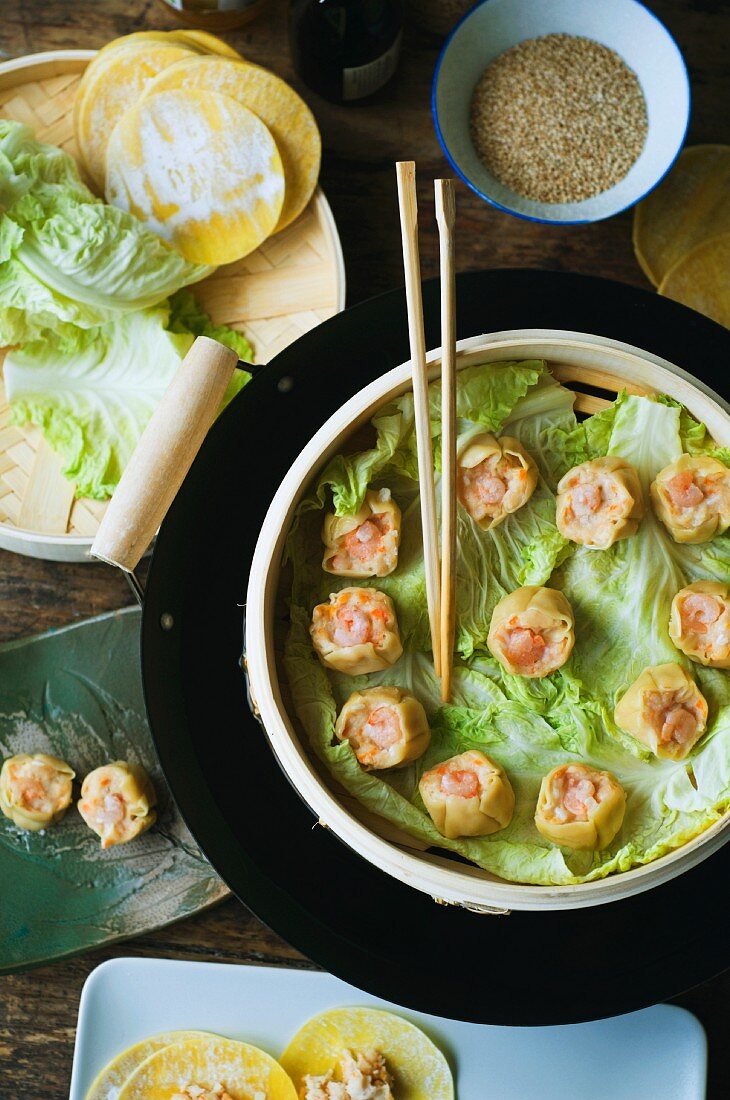 Dim sum in a bamboo basket and ingredients