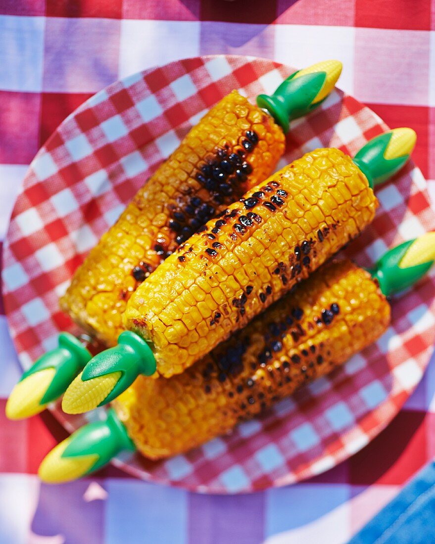 Grilled corn on the cob on a checked tablecloth