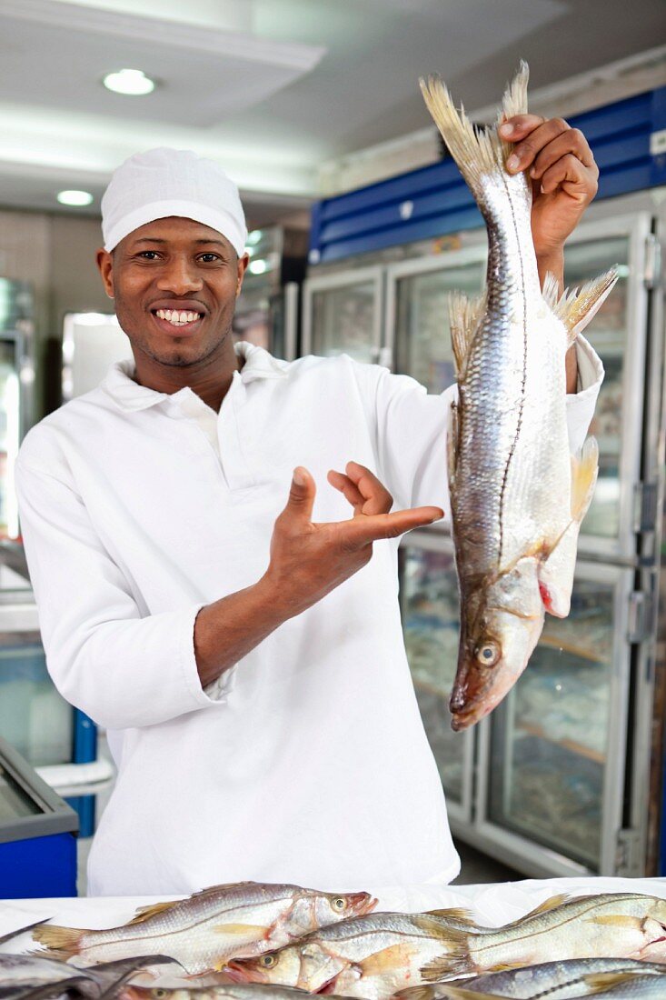 A fish monger with fresh fish