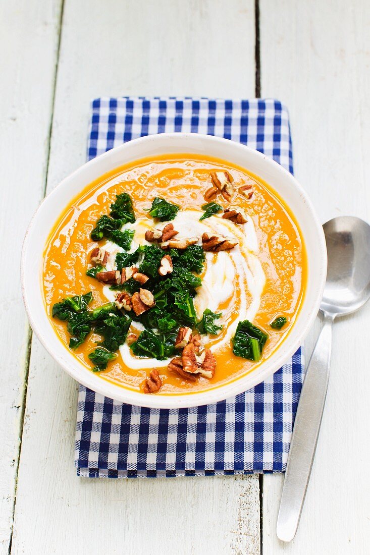 Sweet potato soup with green cabbage and pecan nuts
