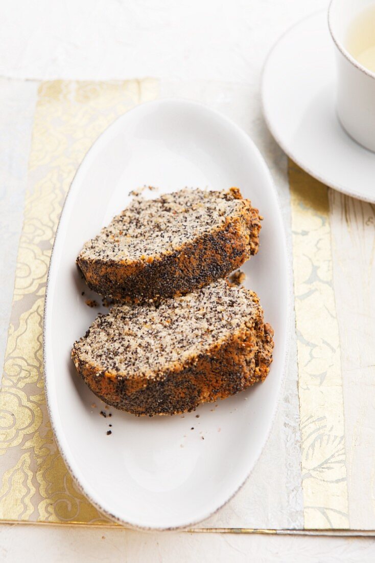 Two slices of poppy seed Bundt cake with a cup of tea