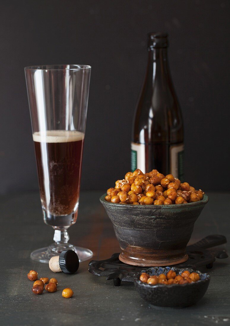 Roasted chickpeas with ginger, spices and sesame seeds and a glass of beer