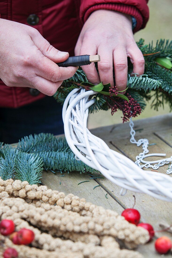 Tying a wreath of branches
