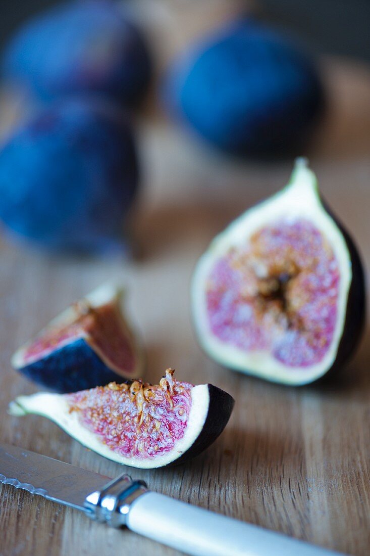 Fresh figs cut with a knife close up.