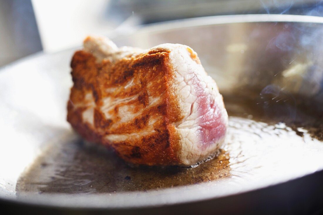 tenderloin beef in a frying pan, for a typical Czech dish called Svickova