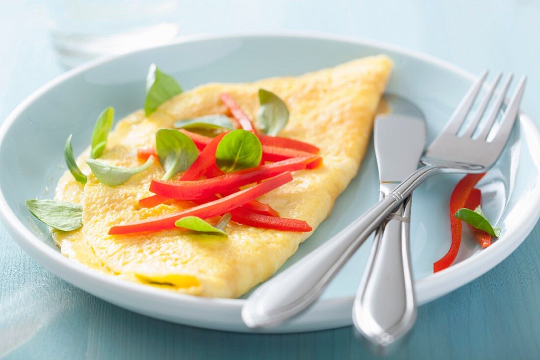 An omelette with pepper and basil