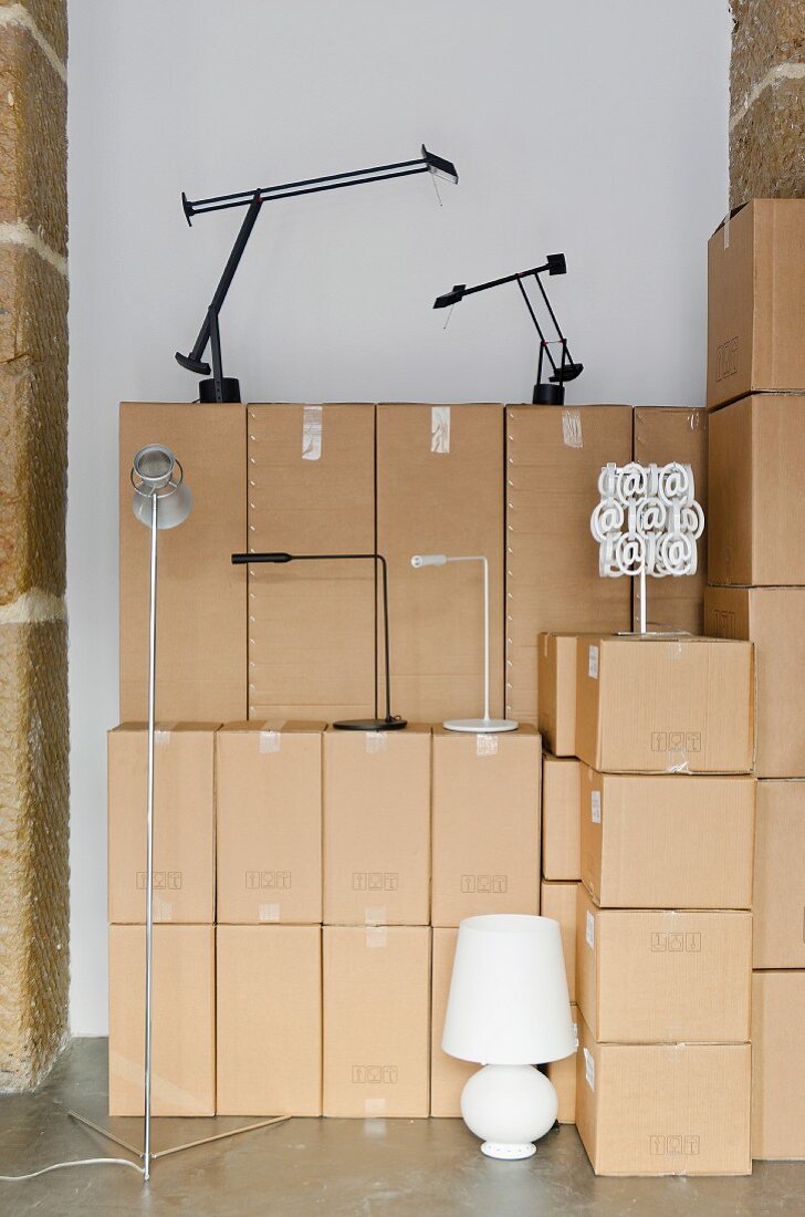Various lamps & stacked packing cases
