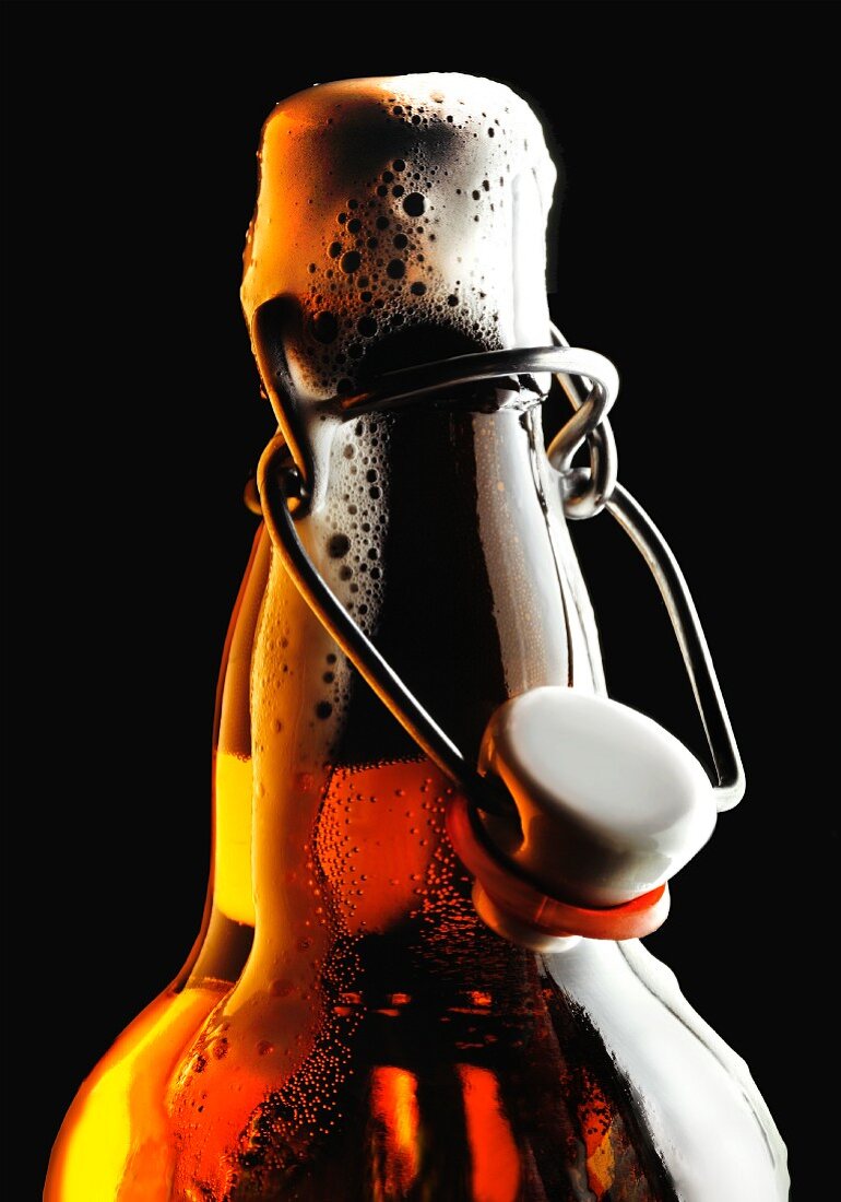 Beer foaming out of a bottle