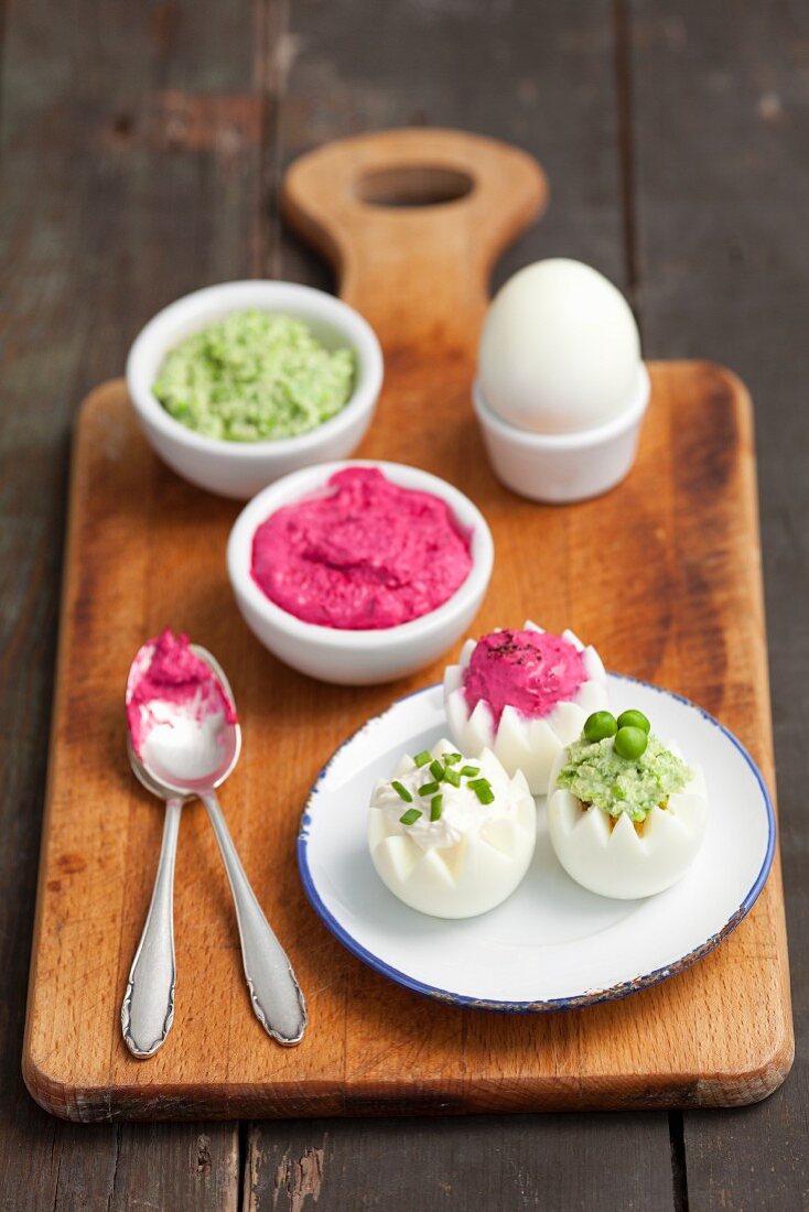 Boiled eggs with three dips: beetroot dip, horseradish dip and pea dip