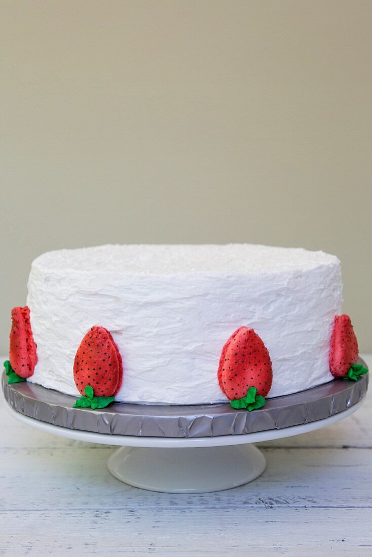 A strawberry cake with vanilla icing