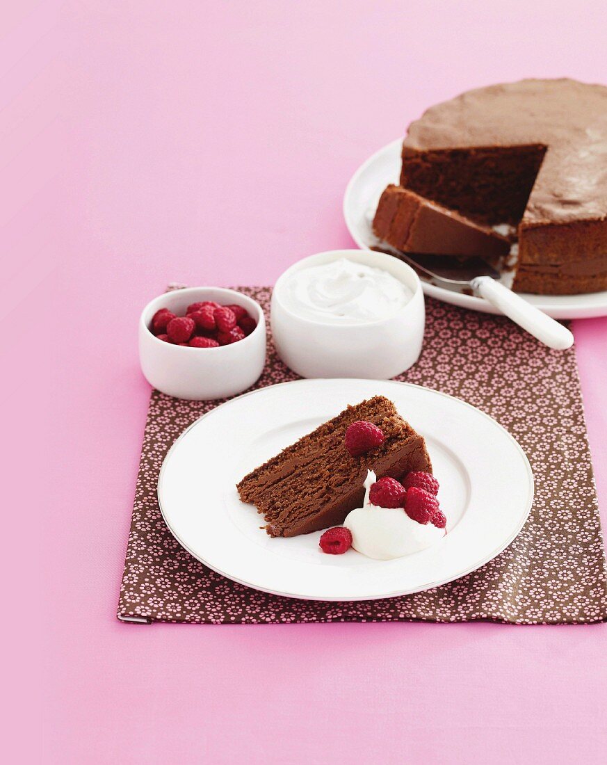 Chocolate caramel cake with raspberries and cream